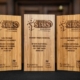 Three Modeshift STARS School Awards stand on table. Wooden awards with stars engraved.