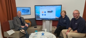 Histrionic's Dave and Modeshift's Cheryl and Nick sit either side of large TV screen around a coffee table. Modeshift STARS Logo is on a second TV screen on the wall.