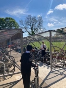 students securing their bikes in bike shelter